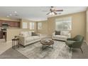 Open-concept living room filled with natural light and neutral furnishings and decor at 15420 W Canterbury Dr, Surprise, AZ 85379