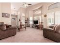 Bright living room with high ceilings, large windows, and neutral carpeting at 1577 E Earl Dr, Casa Grande, AZ 85122