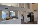 Open-concept floor plan featuring neutral walls, wood flooring, and an abundance of natural light at 16046 W Hearn Rd, Surprise, AZ 85379
