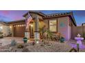 Beautiful exterior featuring a landscaped front yard, cozy porch, and desert-themed decor at 17419 W Georgia Dr, Surprise, AZ 85388