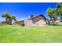 Expansive backyard featuring lush lawn, mature trees, and privacy fencing at 17802 N 45Th Ave, Glendale, AZ 85308