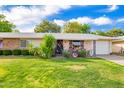 Charming single-story home with a well-maintained lawn and mature landscaping at 17804 N Del Webb Blvd, Sun City, AZ 85373