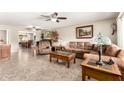 Spacious living room featuring tile floors, ceiling fan and neutral color palette at 17804 N Del Webb Blvd, Sun City, AZ 85373