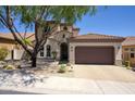 Charming home with a tile roof, manicured front yard, and a spacious three-car garage, offering curb appeal at 18515 N 97Th Way, Scottsdale, AZ 85255