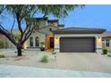 Charming home exterior with a well-maintained yard, driveway, and 2-car garage at 18515 N 97Th Way, Scottsdale, AZ 85255