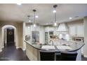 Bright and modern kitchen with a large island and stylish lighting fixtures at 18515 N 97Th Way, Scottsdale, AZ 85255