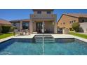 Stunning backyard features a pristine pool with integrated spa, outdoor kitchen, and covered patio for luxurious outdoor living at 18515 N 97Th Way, Scottsdale, AZ 85255