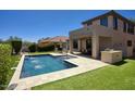 Backyard oasis with a sparkling pool, water features, and patio seating, perfect for outdoor entertaining and relaxation at 18515 N 97Th Way, Scottsdale, AZ 85255