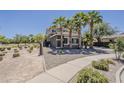 The back corner of this two-story home has desert landscaping and walkway at 18581 E Aubrey Glen Rd, Queen Creek, AZ 85142