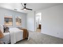 Serene bedroom with neutral tones, plush carpeting, and a view of the en suite bathroom for a relaxing retreat at 19172 E Kingbird Dr, Queen Creek, AZ 85142