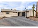 Attractive single-story home featuring a well-kept yard and a spacious driveway at 2001 W Surrey Ave, Phoenix, AZ 85029
