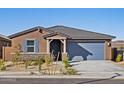 Welcoming single-story home with desert landscaping, stone accents, and a charming covered entrance at 20368 N 224Th Dr, Surprise, AZ 85387