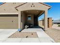 Inviting front porch area with seating and a clear view of the home's entrance and landscaping at 21690 N Lynn St, Maricopa, AZ 85138