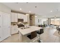Open-concept kitchen featuring an island with bar seating, stainless steel appliances, and modern cabinetry at 21690 N Lynn St, Maricopa, AZ 85138