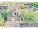 This aerial view displays the home's exterior, terracotta roof, desert landscaping, and wide driveway at 2211 W Desert Ln, Phoenix, AZ 85041