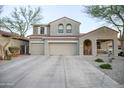Charming two-story home featuring desert landscaping, a two-car garage, and a covered porch at 2211 W Desert Ln, Phoenix, AZ 85041