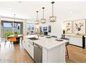 Open-concept kitchen with stainless steel appliances, an island, and pendant lighting at 22490 W Tonopah Dr, Surprise, AZ 85387