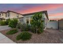 Gray home featuring mature bushes and trees, desert landscaping, and a gray stucco exterior at 22609 E Roundup Way, Queen Creek, AZ 85142