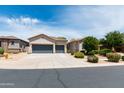 This home features a well-kept front yard, vibrant landscaping, and a spacious three-car garage at 2310 W Sienna Bouquet Pl, Phoenix, AZ 85085