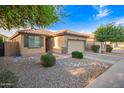 Inviting single-level home with desert landscaping, charming curb appeal, and a two-car garage at 2734 W Bowker St, Phoenix, AZ 85041