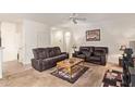Spacious living room with plush seating, neutral carpeting, and a ceiling fan at 2734 W Bowker St, Phoenix, AZ 85041