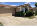 Single-story home with a two-car garage, driveway, and lovely green lawn at 314 E Campo Bello Dr, Phoenix, AZ 85022