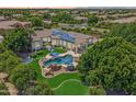 An aerial view of the property showcasing a large pool and solar panels at 3410 E Inglewood Cir, Mesa, AZ 85213