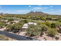 Beautiful aerial view of desert home showcasing mountain views, golf course and desert landscape at 34221 N Boulders Pkwy, Scottsdale, AZ 85266