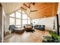 Spacious living room with vaulted wood ceilings and a large window bringing the outside in at 37414 N 17Th Ave, Phoenix, AZ 85086