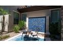 Private patio featuring a blue mosaic water feature and a cozy outdoor seating area at 4281 S Iowa St, Chandler, AZ 85248