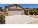 Charming single-Gathering home with desert landscaping, covered entry, and a two-car garage at 43344 W Oster Dr, Maricopa, AZ 85138