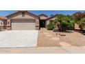 Charming single-Gathering home with desert landscaping, covered entry, and a two-car garage at 43344 W Oster Dr, Maricopa, AZ 85138