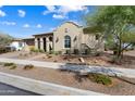 Inviting Southwestern home with decorative arches, desert landscaping, and a charming front yard pathway at 5033 N 205Th Gln, Buckeye, AZ 85396