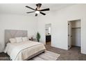 Cozy bedroom with neutral tones, carpet flooring, and a ceiling fan at 51134 W Bluejay St, Maricopa, AZ 85139