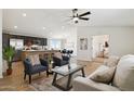 Inviting living room with stylish furniture, ceiling fan, and an open floor plan at 51134 W Bluejay St, Maricopa, AZ 85139