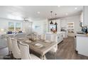 Open concept view of the dining room and kitchen feature modern finishes and lots of natural light at 51942 W Sotol Rd, Maricopa, AZ 85139