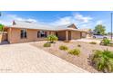 Inviting single-story home featuring desert landscaping and a paved driveway at 5320 W Maui Ln, Glendale, AZ 85306