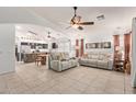 Expansive open-concept living room featuring tile flooring, and seamless flow to the modern kitchen at 6002 N 124Th Dr, Litchfield Park, AZ 85340