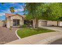 Inviting home featuring lush green grass, well-manicured landscaping, and a neatly paved walkway, enhancing curb appeal at 605 S Monterey St, Gilbert, AZ 85233