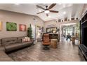 Cozy living room with wood-look tile flooring, neutral decor, and an open layout, ideal for entertaining guests at 605 S Monterey St, Gilbert, AZ 85233