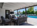 Inviting outdoor patio area with comfortable seating and a view of the pool at 6413 E Parkview Dr, Scottsdale, AZ 85257