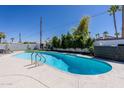 Inviting pool area featuring a sparkling blue pool, a spacious deck, and tropical landscaping at 6413 E Parkview Dr, Scottsdale, AZ 85257