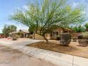 Quaint single-story home with a two-car garage and sidewalk at 7037 W Cavalier Dr, Glendale, AZ 85303