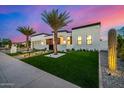 Modern home features a manicured lawn, stylish landscaping, and a sleek architectural design at 8549 E Indianola Ave, Scottsdale, AZ 85251
