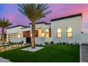 Features a modern design with a well-manicured lawn and elegant desert landscaping at 8549 E Indianola Ave, Scottsdale, AZ 85251