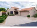 Charming home featuring a red tile roof, neutral stucco exterior, and well-manicured landscaping at 8635 W Country Gables Dr, Peoria, AZ 85381