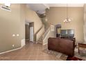 Spacious living area with tile floors and staircase leading to the second floor at 9343 W Quail Ave, Peoria, AZ 85382
