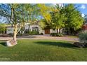 Beautifully landscaped front yard and well-maintained lawn highlight this home's curb appeal at 11331 E Cochise Dr, Scottsdale, AZ 85259
