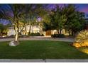 Well-manicured lawn and mature trees frame this beautiful home and entrance at 11331 E Cochise Dr, Scottsdale, AZ 85259