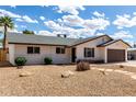 Charming single-story home with a two-car garage and desert landscaping on a sunny day at 1203 E Bishop Dr, Tempe, AZ 85282